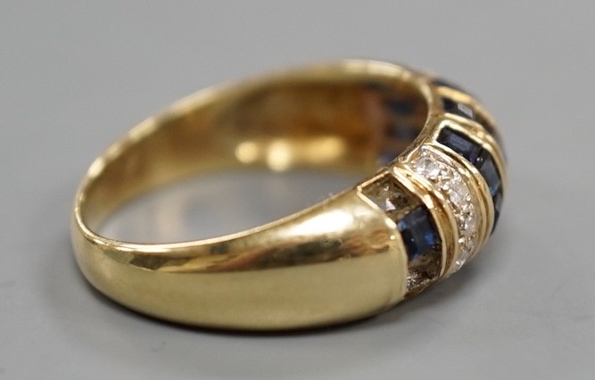 A modern yellow metal, sapphire chip and diamond chip set half hoop cluster ring, size M/N, ross weight 3.6 grams(two sapphires missing).
